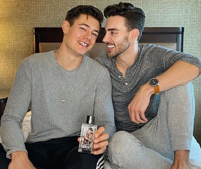 Caption: Travis Bryant posing along with his boyfriend (Source: Instagram) ...