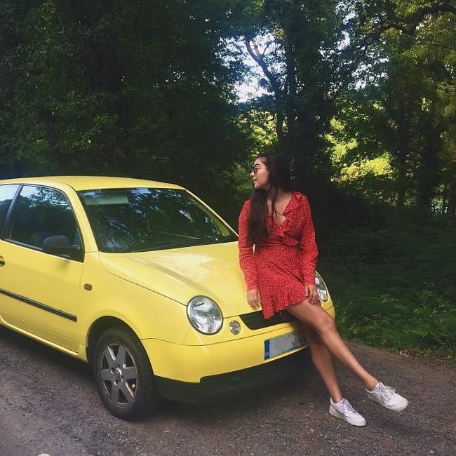 Priya Blackburn posing with a car