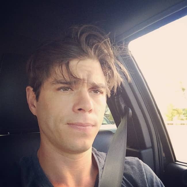 Matthew Lawrence posing in his car (Source Instagram)