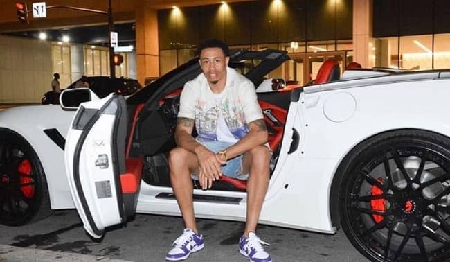 A. J. Slaughter posing with his car (Source Instagram).