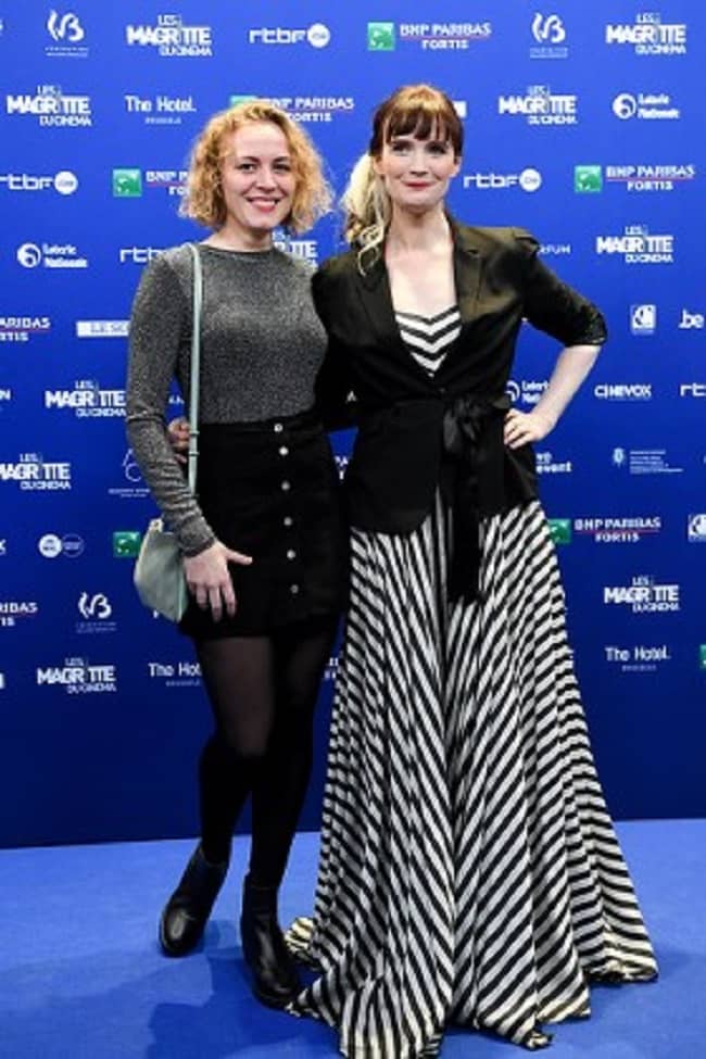 Anne Pascale Clairembourg posing for a photo with friend (Source Shutterstock)